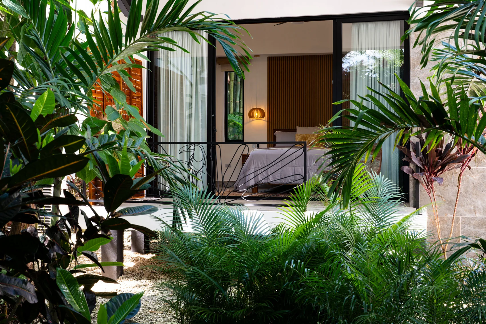 Garden casita glimpsed through tropical planting