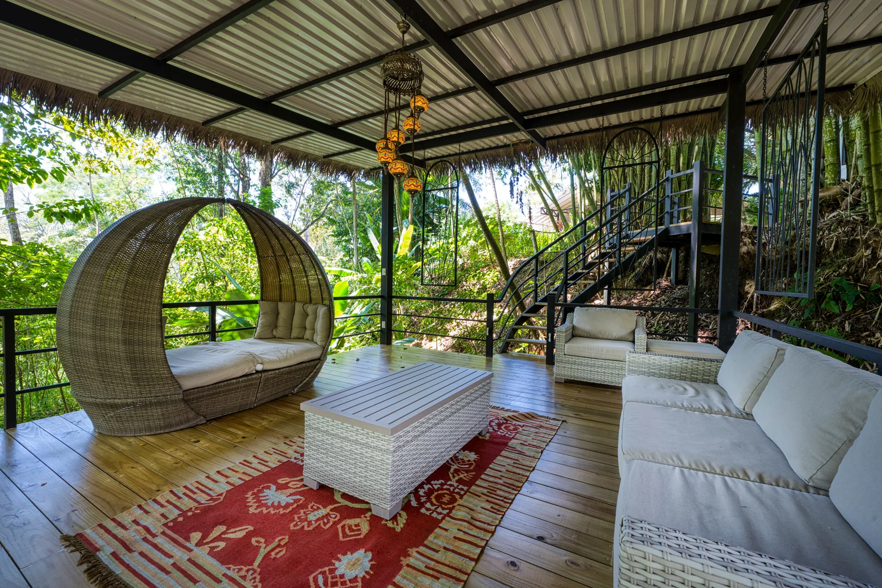 A round daybed beside the bamboo