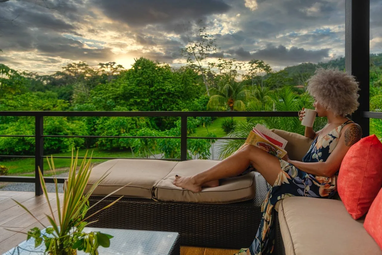 A guest reading on the open-air lounge at sunset