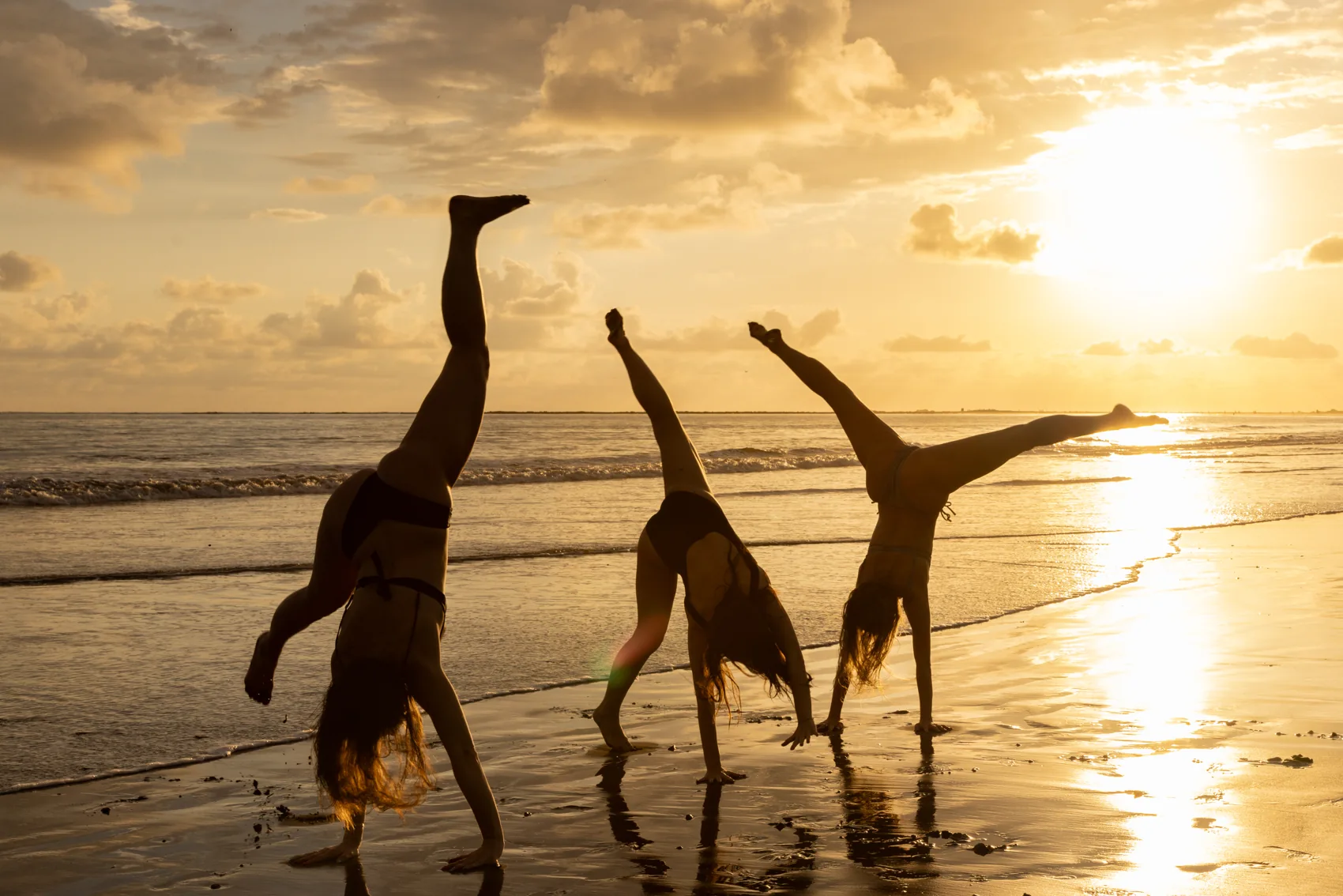 Cartwheels at the water’s edge at sunset