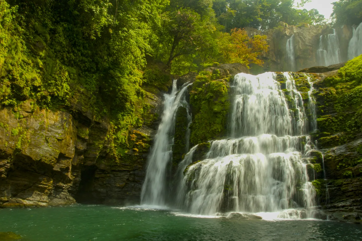 A waterfall in the green landscape around Uvita